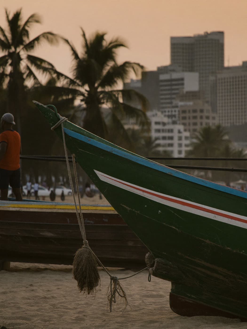 Traditional fishing boats on Marina Beach in Chennai, India at dusk