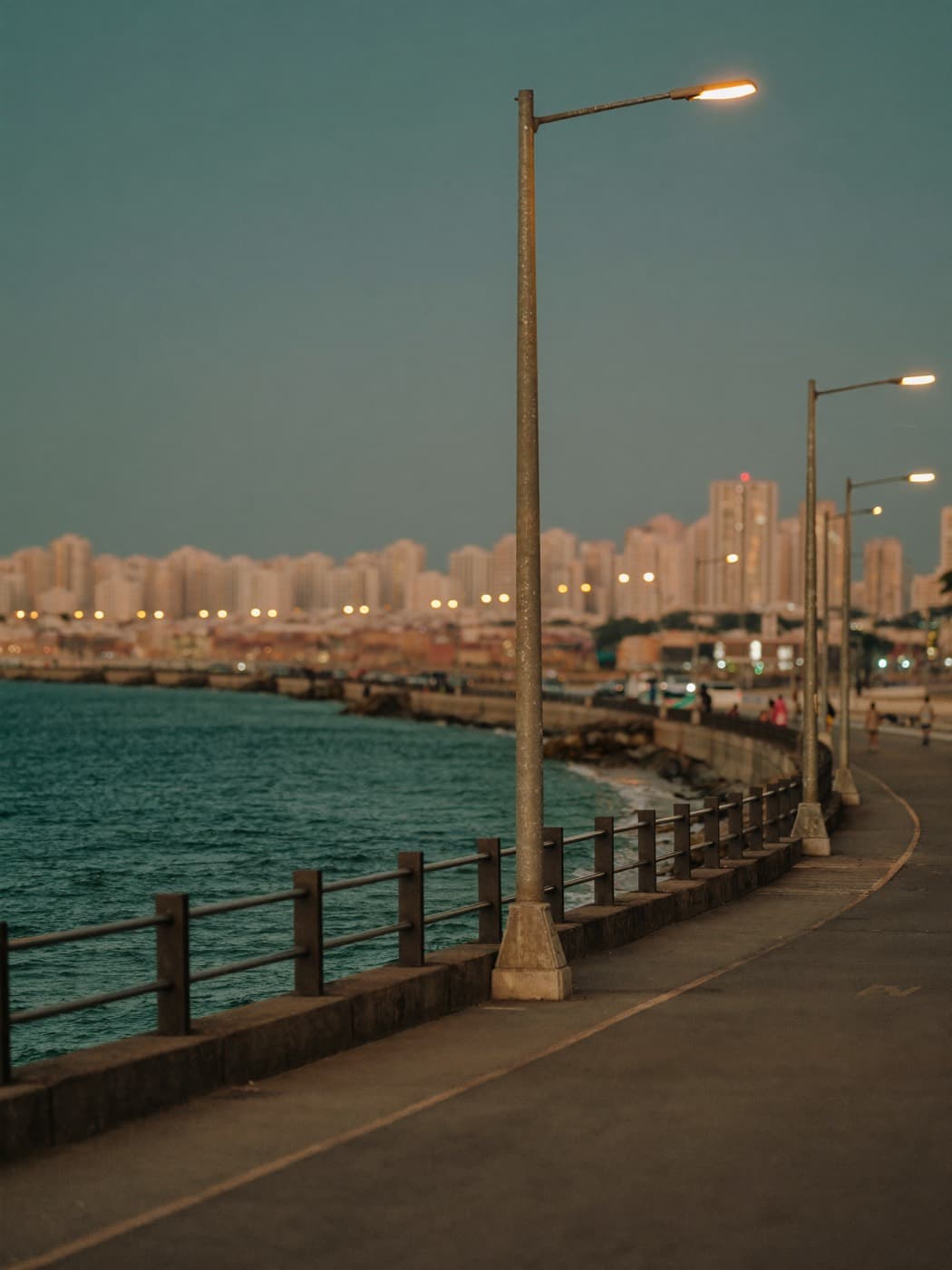 A coastal promenade in Mumbai, India at blue hour